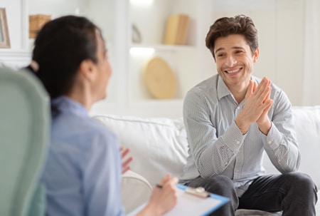 A happy man talking to a therapist