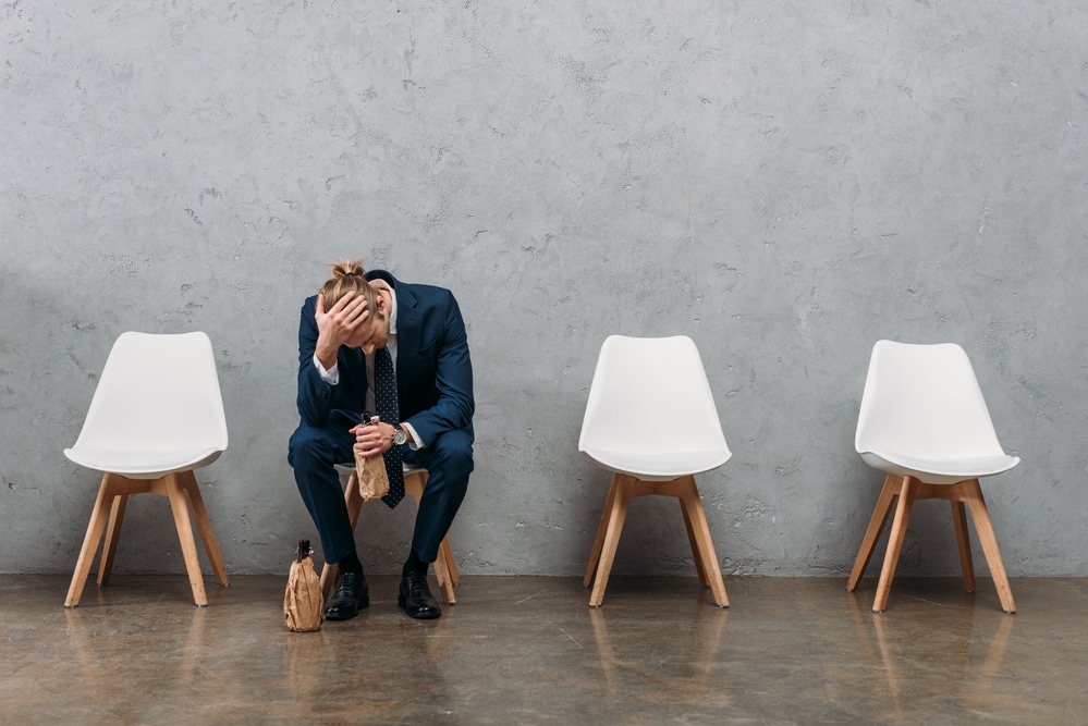 troubled businessman sitting on a chair