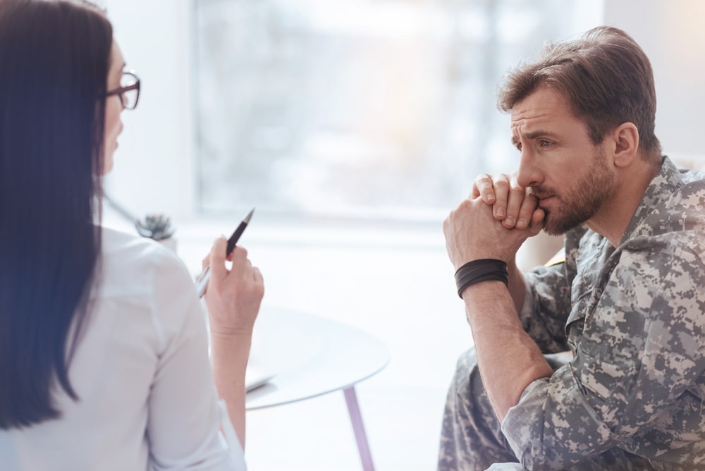 Depressed soldier and his psychotherapist during a military mental health therapy session.