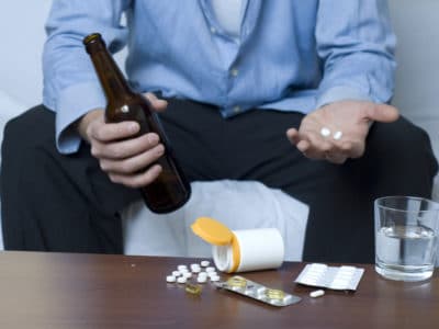 an addicted person with prescription drugs and alcohol abuse problem