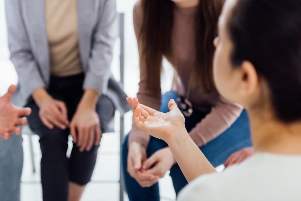 Schizophrenic patients having a discussion at a group therapy