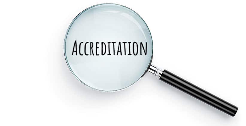 Magnifying glass over the word accreditation