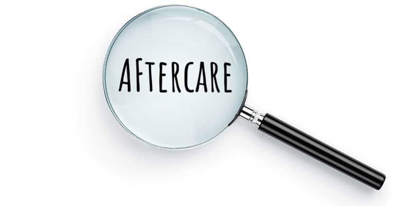 Magnifying glass over the word aftercare.