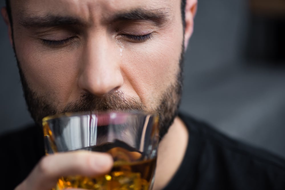 man with untreated mental illness drowning it with alcohol and making condition worse