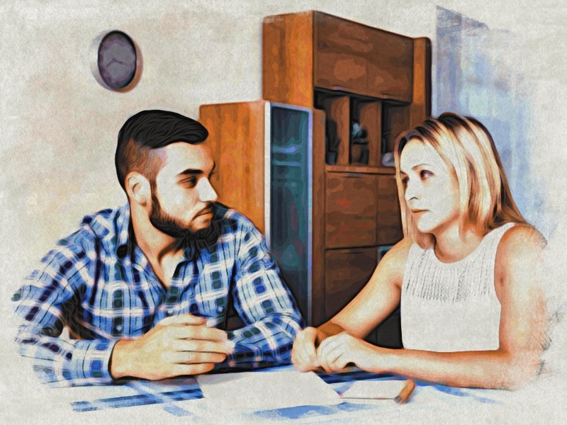 Photo of a couple discussing family addiction at the kitchen table