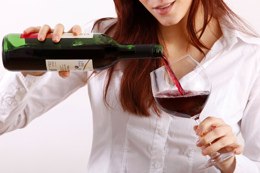 female binge drinking wine after work