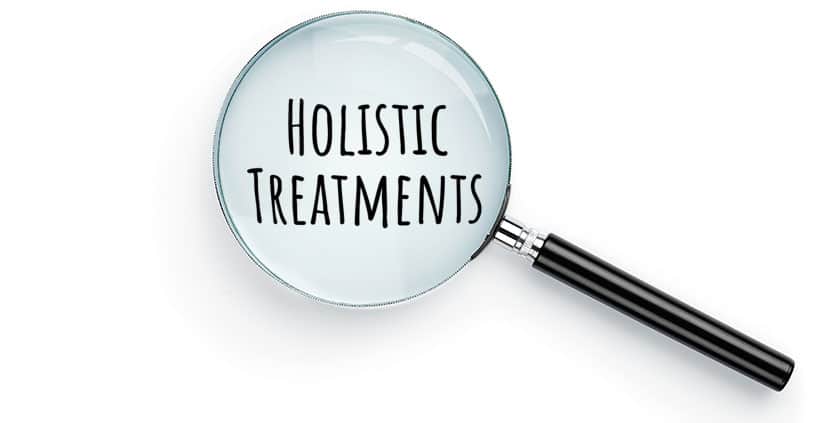 Magnifying glass over the words holistic treatments