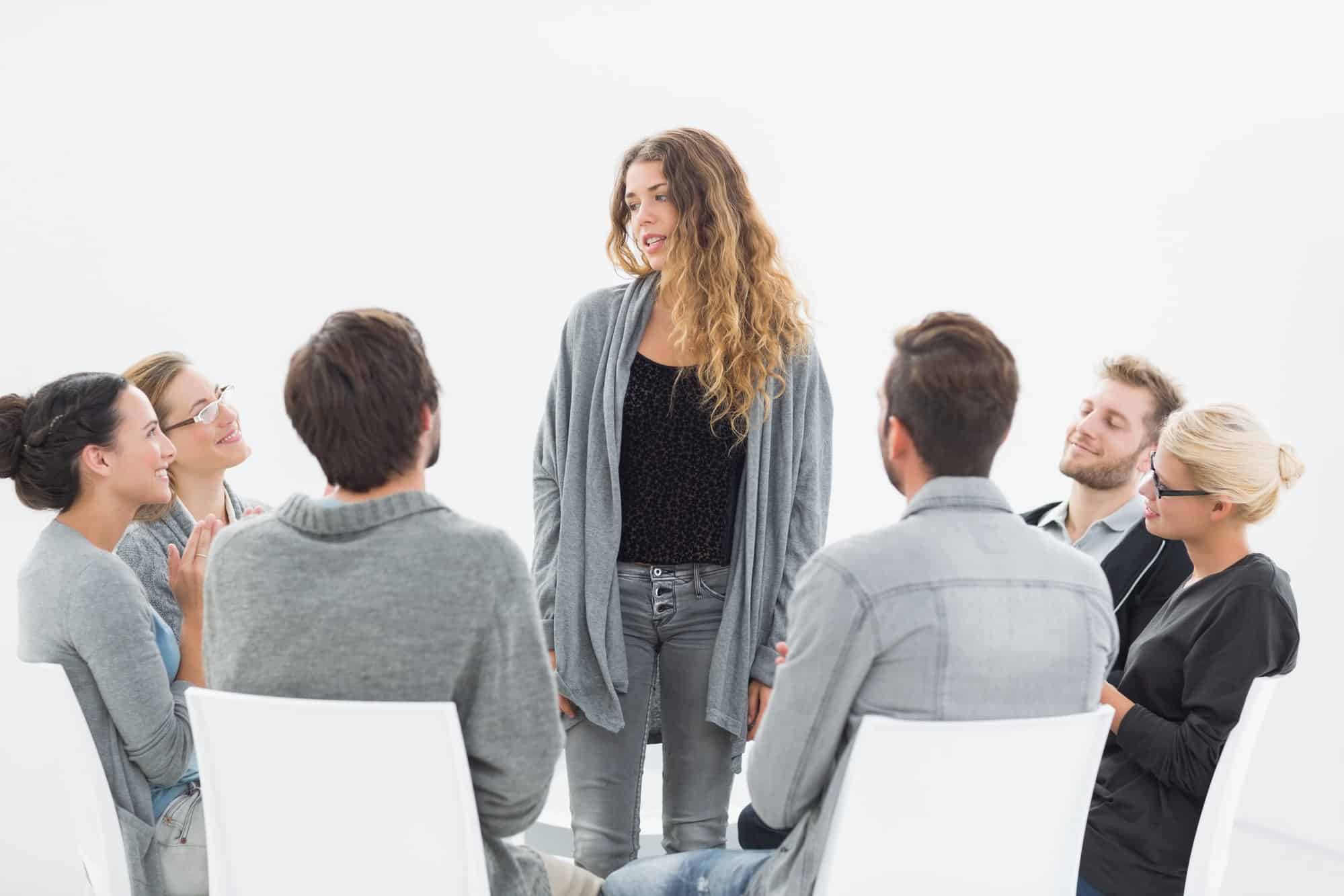 woman sharing experience in a group therapy session