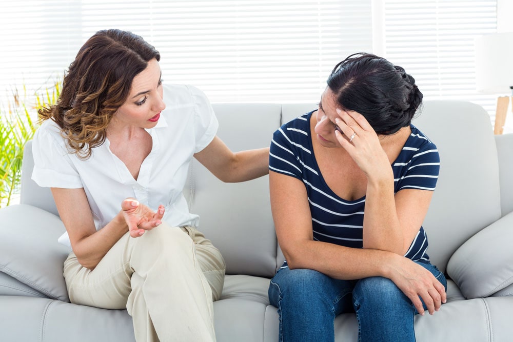 Woman asking her therapist "can i work and attend outpatient addiction treatment?" before beginning treatment