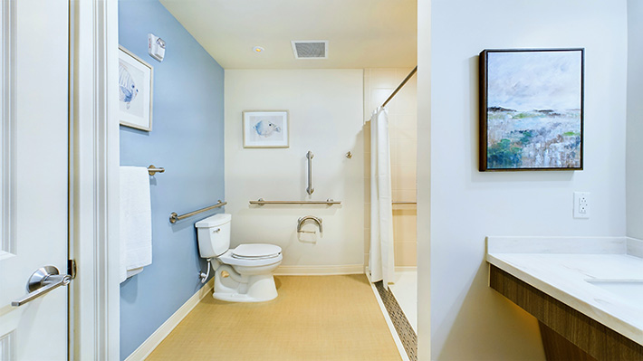 a serene hotel-like bathroom with powder blue and white walls