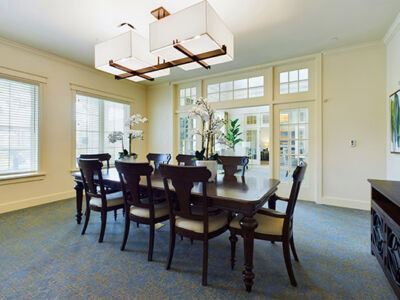 a well lit conference room with a big table and 8 chairs