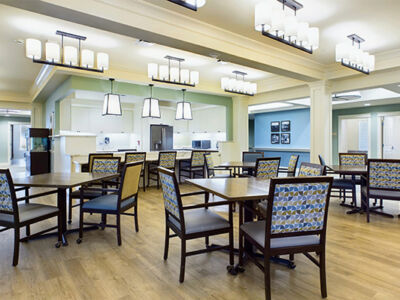 a very pleasant dining hall and kitchen with attractive blue and green walls.