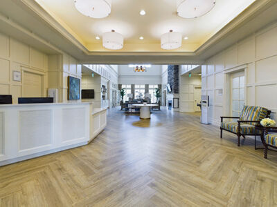 a large lobby area with couches and lots of sunlight.