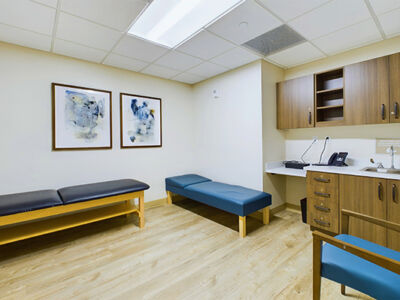 a cozy version of a medical office with massage benches and a sink.