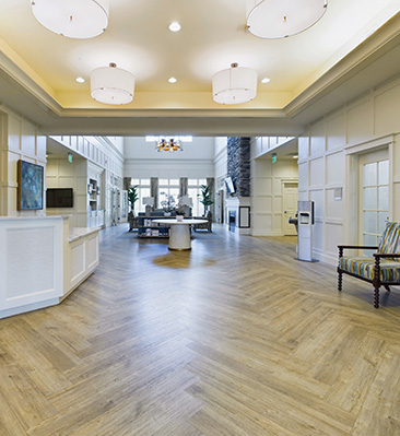 a large lobby area with couches and lots of sunlight.