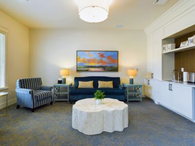 a waiting room for families with elegant sofa chairs and many amenities