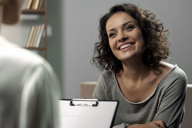 a doctor reading good results to a female patient